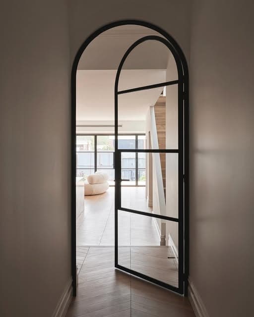 Arched black-framed aluminium glass door
